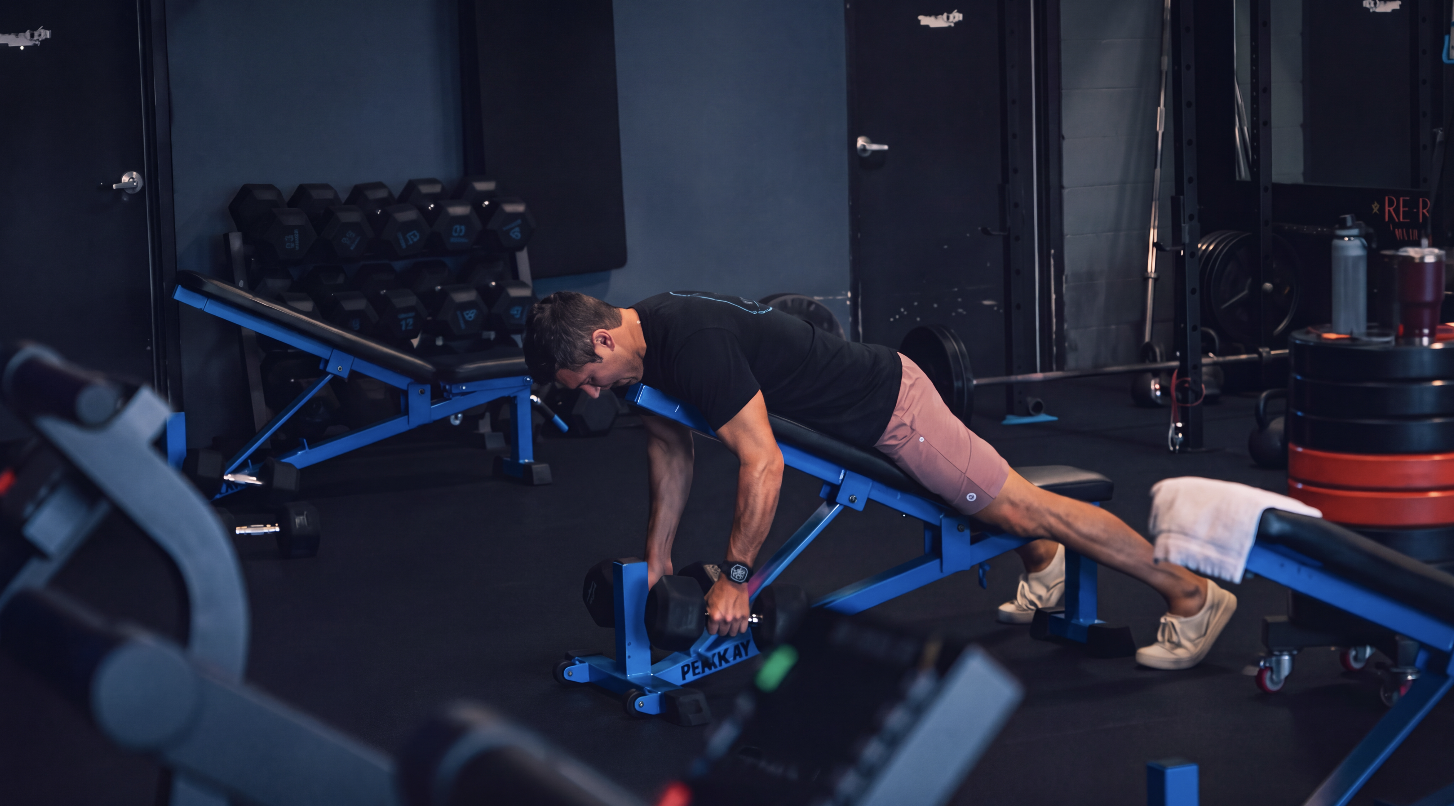 Member performing a chest supported dumbbell row at TitanUp Jacksonville Beach