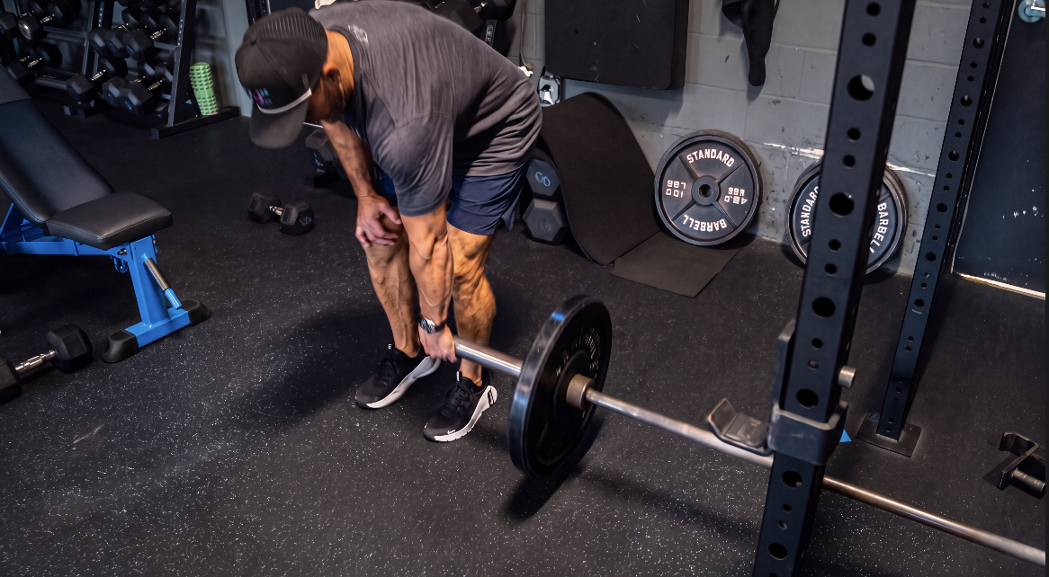 TitanUp member pulling a bent over barbell row on the training floor
