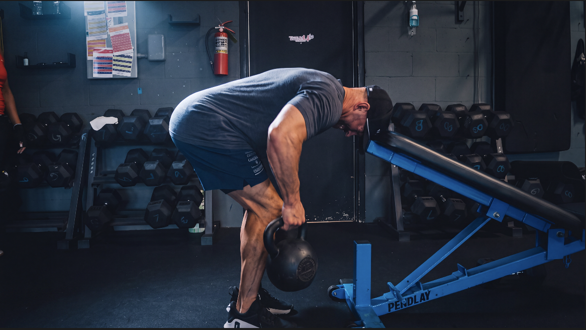 TitanUp member rowing a kettlebell on the training floor