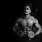 Photo by DreamLens Production from Pexels: https://www.pexels.com/photo/grayscale-photo-of-a-man-holding-pair-of-dumbbells-896062/