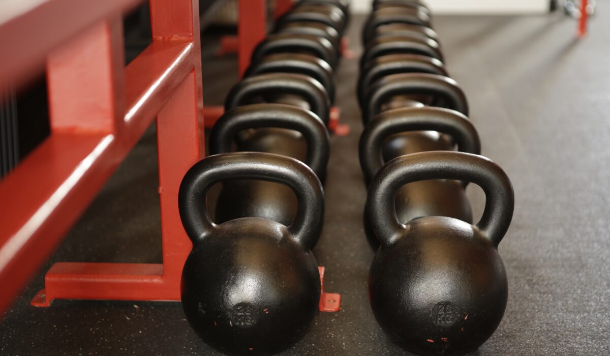 several black barbell cowbells on the floor for workout, exercise